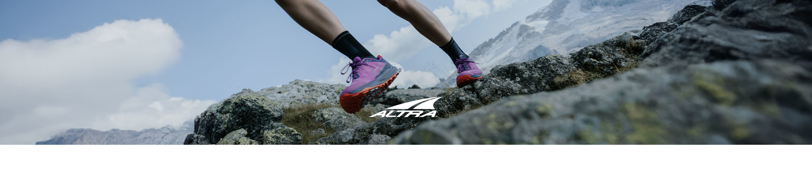 Shop Altra running shoes. A runner wearing Lone Peak running shoes on a trail path